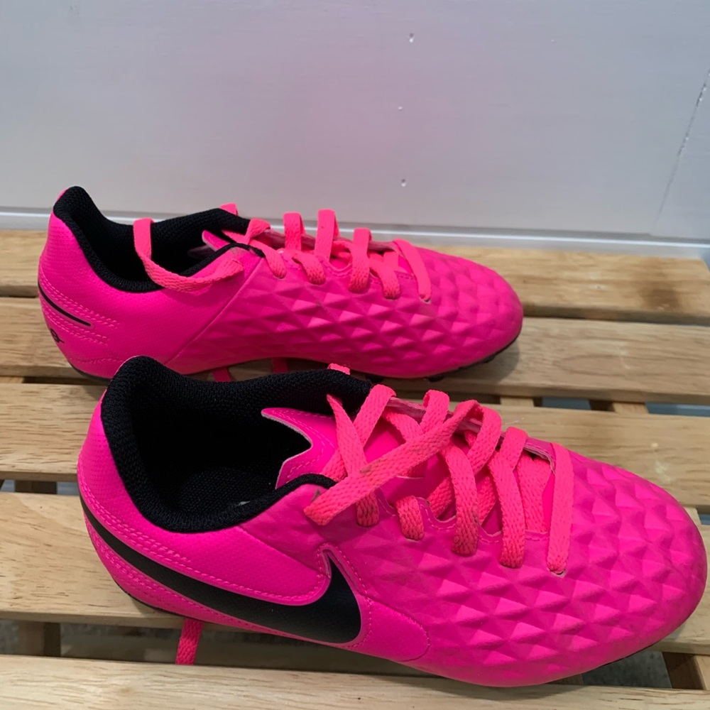 Hot pink Nike Tiempo cleats.